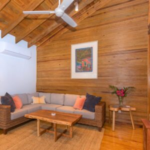 A living room with wood walls and furniture.