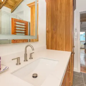 A bathroom with a sink and mirror in it