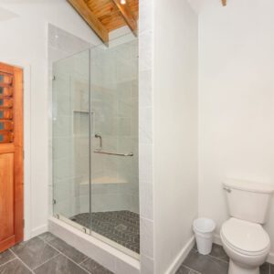 A bathroom with a toilet and shower in it