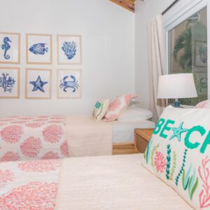 A bedroom with pink and white decor on the walls.