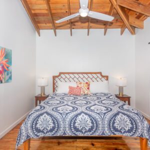 A bed room with a blue and white bedspread