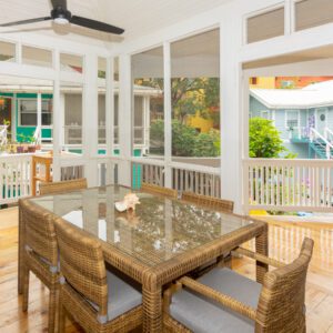 A dining room with a table and chairs in it