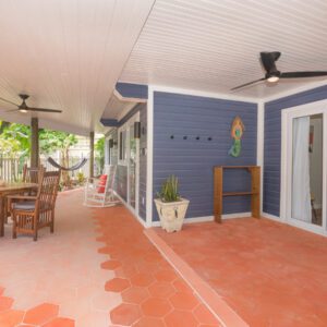 A patio with an umbrella and chairs in it