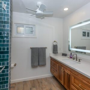 A bathroom with a sink, mirror and toilet.