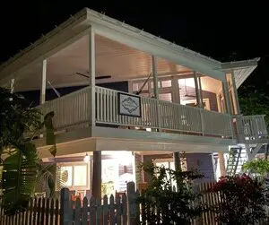 A house with a porch and balcony at night.